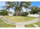 Charming curb appeal with a large oak tree and manicured lawn at 3109 Ohara Dr, New Port Richey, FL 34655