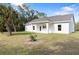 White house with covered patio and spacious backyard at 4551 Wilcox Ave, North Port, FL 34288