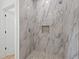 Large walk-in shower with marble tile and pebble floor at 4551 Wilcox Ave, North Port, FL 34288