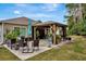 Spacious backyard featuring a gazebo, patio area and manicured lawn under a blue sky at 5021 Gato Del Sol Cir, Wesley Chapel, FL 33544