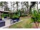 Landscaped backyard with a patio, gazebo, comfortable seating and tropical plants at 5021 Gato Del Sol Cir, Wesley Chapel, FL 33544