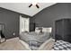 Cozy bedroom with a patterned bedspread, accent wall, and a ceiling fan at 5021 Gato Del Sol Cir, Wesley Chapel, FL 33544