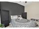 Stylish bedroom with an accent wall, pattern bedding, neutral carpet, and closet space at 5021 Gato Del Sol Cir, Wesley Chapel, FL 33544