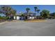 Community clubhouse with palm trees and parking at 5021 Gato Del Sol Cir, Wesley Chapel, FL 33544