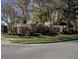 Pimlico Village community entrance featuring stone columns, landscaping, and an inviting neighborhood sign at 5021 Gato Del Sol Cir, Wesley Chapel, FL 33544