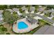 Aerial view of the community pool area with seating, a covered pavilion, and well-maintained landscaping at 5021 Gato Del Sol Cir, Wesley Chapel, FL 33544