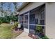 Inviting screened entryway with decorative plants and a welcome sign at 5021 Gato Del Sol Cir, Wesley Chapel, FL 33544