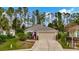 Charming single-story home featuring a well-manicured lawn and a two-car garage at 5021 Gato Del Sol Cir, Wesley Chapel, FL 33544