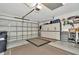 Spacious garage with white cabinets and storage area providing ample space for vehicles and organization at 5021 Gato Del Sol Cir, Wesley Chapel, FL 33544