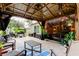 Outdoor gazebo with comfortable seating, string lights, ceiling fan and view of the lush backyard at 5021 Gato Del Sol Cir, Wesley Chapel, FL 33544