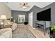 Relaxing living room with neutral walls, a ceiling fan, and comfortable seating at 5021 Gato Del Sol Cir, Wesley Chapel, FL 33544