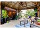Relaxing outdoor patio with a covered pergola, seating, and stylish decor at 5021 Gato Del Sol Cir, Wesley Chapel, FL 33544