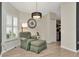 Cozy sitting area with a comfortable armchair and a stylish chandelier at 5021 Gato Del Sol Cir, Wesley Chapel, FL 33544