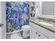 Updated bathroom features granite countertop, white vanity, and a patterned shower curtain at 521 34Th N Ave, St Petersburg, FL 33704