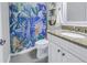 Updated bathroom features granite countertop, white vanity, and a patterned shower curtain at 521 34Th N Ave, St Petersburg, FL 33704