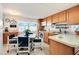 Cozy kitchen with light wood cabinets and a dining area at 5212 Betmar Dr, Zephyrhills, FL 33542