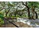 Peaceful park with benches under large oak trees at 5212 Betmar Dr, Zephyrhills, FL 33542
