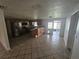 Open concept kitchen and dining area with tiled floors, wooden cabinets, and access to the backyard at 5305 Rawls Rd, Tampa, FL 33625