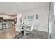 Dining area with glass table and white chairs, open to kitchen at 6774 Shelby Lynn Way, Zephyrhills, FL 33542