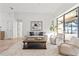 Bright living room with comfy seating, a coffee table, and large windows at 7044 Fallbrook Ct, New Port Richey, FL 34655