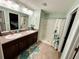 Double vanity bathroom with shower stall and granite countertop at 9736 Sage Creek Dr, Sun City Center, FL 33573