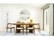 Dining room with a wood table, six chairs, and a large circular mirror at 12214 Radiant Gem Trl, Parrish, FL 34219