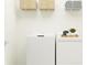 Bright laundry room with washer, dryer, and overhead shelving for storage at 12218 Radiant Gem Trl, Parrish, FL 34219