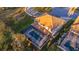 Aerial view of a beautiful house with a screened-in pool and well-maintained landscaping at 13019 Paddock Wood Pl, Riverview, FL 33579