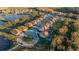 Aerial view of a home with a screened pool in a suburban neighborhood near a pond at 13019 Paddock Wood Pl, Riverview, FL 33579