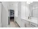 Well-lit bathroom featuring double vanities, and a doorway to another bedroom at 13019 Paddock Wood Pl, Riverview, FL 33579