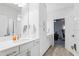 Modern white bathroom with a vanity and white cabinets at 13019 Paddock Wood Pl, Riverview, FL 33579