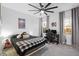 Well-lit bedroom with a ceiling fan, comfortable bed, and gaming setup at 13019 Paddock Wood Pl, Riverview, FL 33579