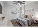 Cozy bedroom featuring a comfortable bed, decorative wall art, and a ceiling fan at 13019 Paddock Wood Pl, Riverview, FL 33579