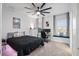 Modern bedroom with ceiling fan, bed, desk, and window seating at 13019 Paddock Wood Pl, Riverview, FL 33579