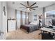 Comfortable bedroom with a ceiling fan, desk area, and neutral decor creating a relaxing space at 13019 Paddock Wood Pl, Riverview, FL 33579