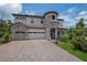 Beautiful two-story home featuring a turret, three-car garage, and well-manicured lawn at 13019 Paddock Wood Pl, Riverview, FL 33579
