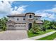 Stunning two-story home with a turret, tile roof, brick driveway, and well-maintained landscaping at 13019 Paddock Wood Pl, Riverview, FL 33579
