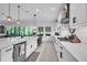 Well-lit kitchen with white countertops, a farmhouse sink, and contemporary fixtures at 13019 Paddock Wood Pl, Riverview, FL 33579