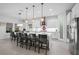 Modern white kitchen with large island, stainless steel appliances, and seating at 13019 Paddock Wood Pl, Riverview, FL 33579