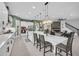 Spacious open kitchen with white cabinetry, a large island, and seamless flow to living area at 13019 Paddock Wood Pl, Riverview, FL 33579
