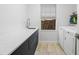 Functional laundry room with a long countertop, undermount sink, and modern washer and dryer at 13019 Paddock Wood Pl, Riverview, FL 33579