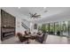Stylish living room with stone accent wall, modern fireplace, and staircase to the upper level at 13019 Paddock Wood Pl, Riverview, FL 33579