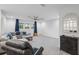Bright and airy living room with large windows, modern furniture, and a stylish ceiling fan at 13019 Paddock Wood Pl, Riverview, FL 33579