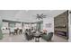 Open-concept living space with stone fireplace, large ceiling fan, and view to the kitchen at 13019 Paddock Wood Pl, Riverview, FL 33579