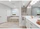 Modern main bathroom featuring a soaking tub and a large shower with neutral colors at 13019 Paddock Wood Pl, Riverview, FL 33579