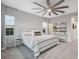 Bright main bedroom with a cozy bed, a ceiling fan, and natural light from windows at 13019 Paddock Wood Pl, Riverview, FL 33579