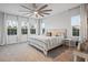 Serene main bedroom with large windows, a ceiling fan, and neutral decor at 13019 Paddock Wood Pl, Riverview, FL 33579
