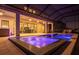 The covered outdoor pool and spa offer a luxurious experience near the home's entertainment area at 13019 Paddock Wood Pl, Riverview, FL 33579