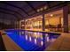 Resort-style pool with serene water and reflections at night at 13019 Paddock Wood Pl, Riverview, FL 33579