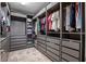Spacious walk-in closet with custom shelving and drawer units providing plenty of storage at 13019 Paddock Wood Pl, Riverview, FL 33579